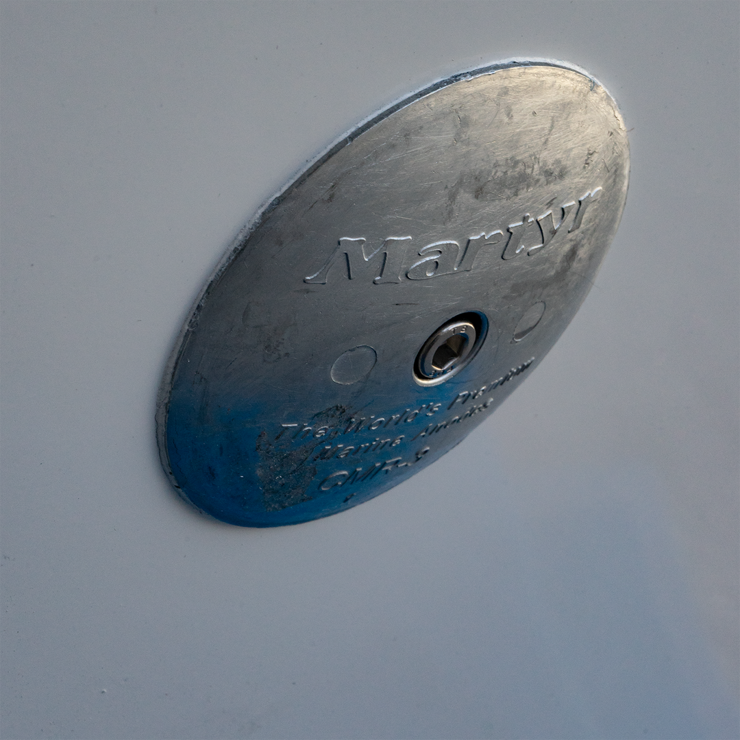 Alt text: "Close-up of a circular metal bracket labeled 'Marty,' designed for a standard Apex Mk. II twin engine, featuring a -13° transom angle