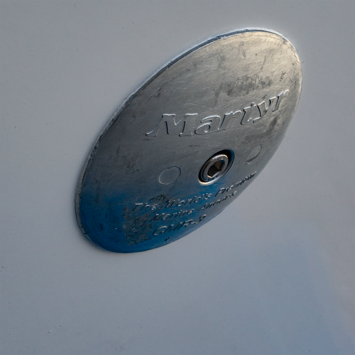 Alt text: "Close-up of a circular metal bracket labeled 'Marty,' designed for a standard Apex Mk. II twin engine, featuring a -13° transom angle