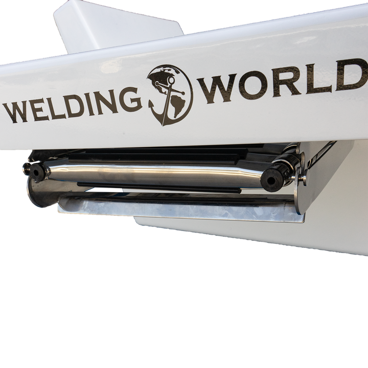 A close-up of a white boat transom with the logo and text "Welding World" printed on it. The logo features a globe with a welding helmet and a welding torch. The transom has a metal roller or support attached underneath. The background is transparent with a checkered pattern