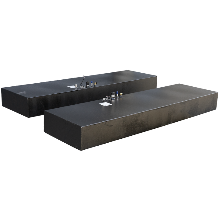 Two long, rectangular fuel tanks with a dark, textured finish, each equipped with multiple fittings on their top surfaces, including blue-capped vents, brass-colored ports, and a central circular access point with wires. These tanks are part of a Twin Vee 260 Plastic to Aluminum Conversion Saddle Fuel Tank Combo Kit, designed to replace existing plastic tanks