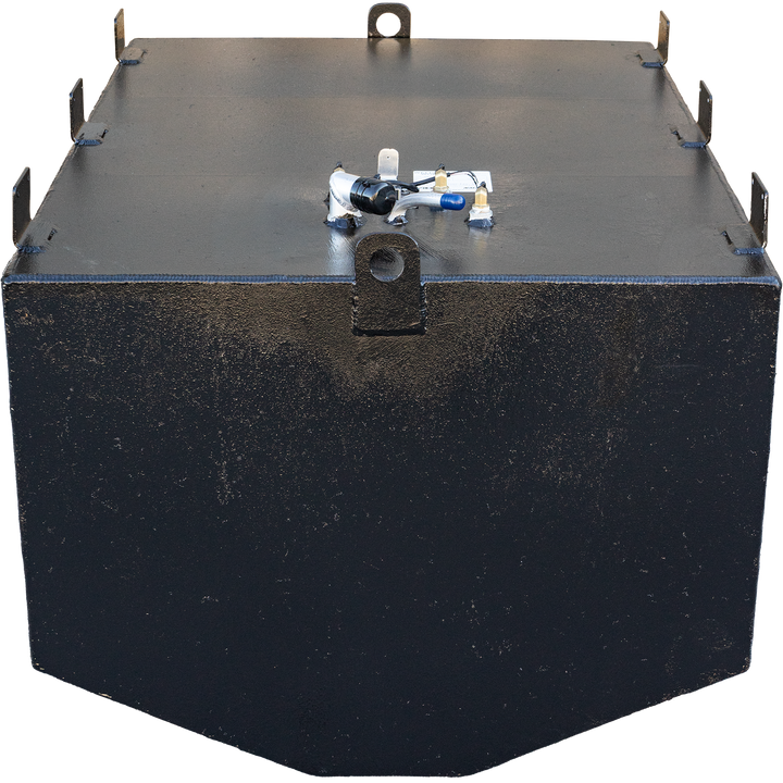 A black, heavily textured, rectangular fuel tank with an angled bottom edge and a checkered background. The tank features various gauges and connections on its top surface, along with metal loops on the front and back for securing it